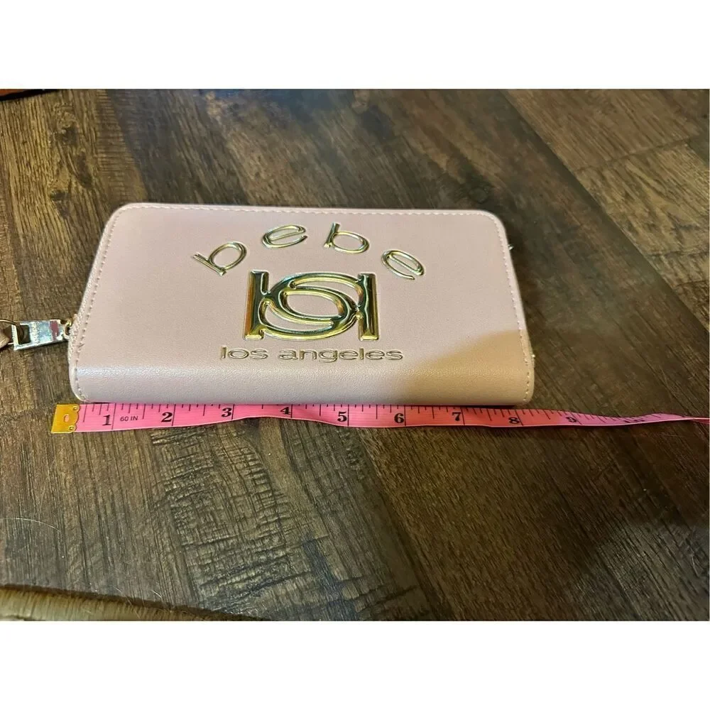 BEBE Pink and gold, large wristlet. Lots of room never used.